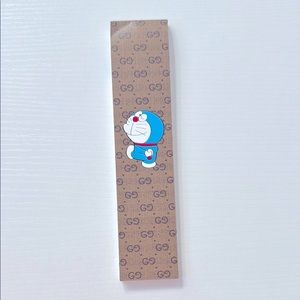 Gucci Notepad Brown and unbranded gold pen in case. Features a playful pattern.